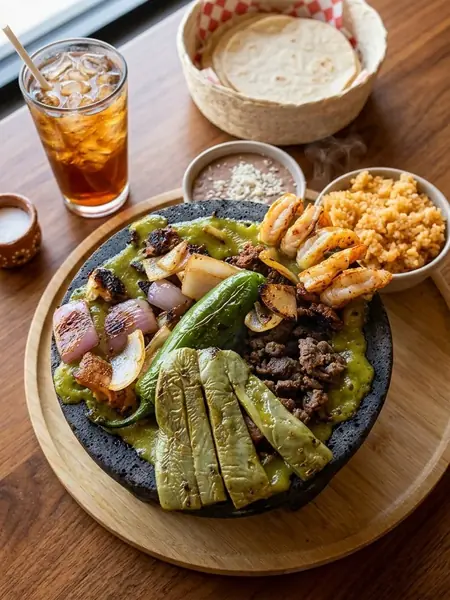 Molcajete Mixto with grilled steak, shrimp, nopales and salsa verde at MEXIKAN in Chappelle, Edmonton