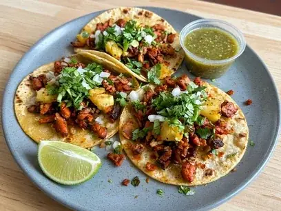 Al pastor tacos with pineapple, onion and cilantro