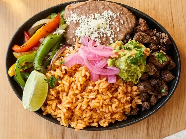 Carne asada platter with Mexican rice, house beans, guacamole and pickled onion at MEXIKAN in Heritage Valley, Edmonton