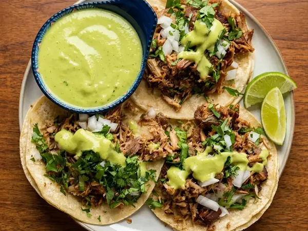 Carnitas tacos with cilantro, onion and avocado salsa at MEXIKAN in Heritage Valley, Edmonton