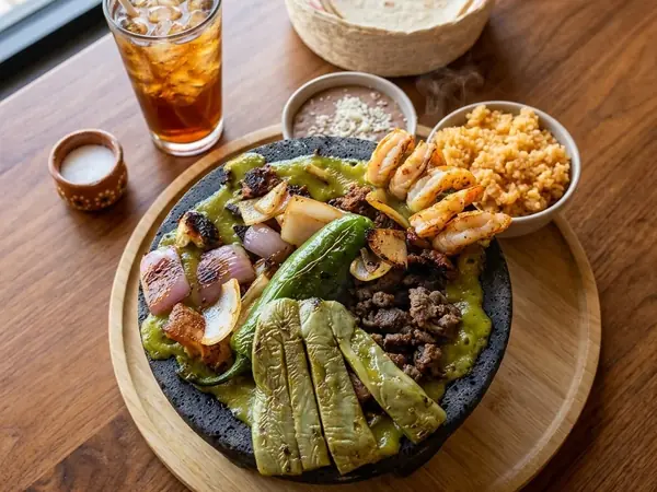 Molcajete Mixto with grilled steak, shrimp, nopales and salsa verde at MEXIKAN in Heritage Valley, Edmonton