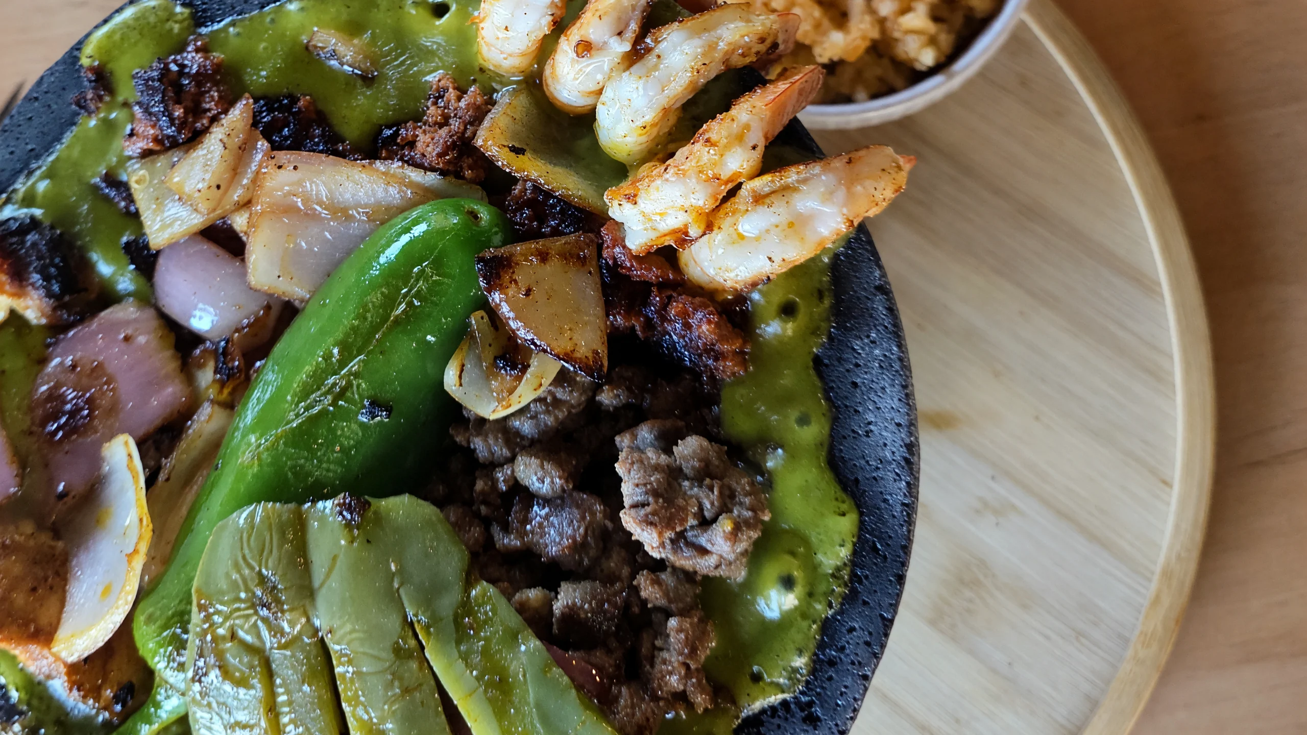 Molcajete Mixto with grilled steak, shrimp, nopales and salsa verde at MEXIKAN in Chappelle, Edmonton