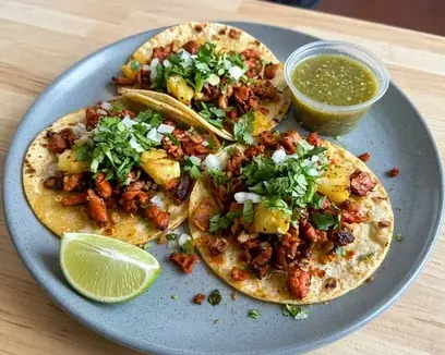 Al pastor tacos with pineapple, onion and cilantro